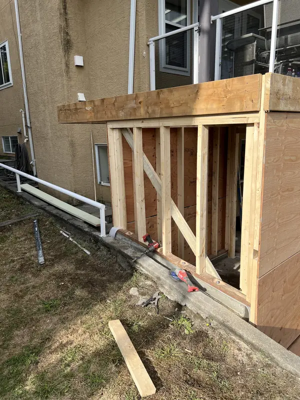 New 2x4 wall framing closing in the space under a raised deck
